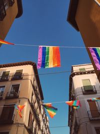 Low angle view of flags hanging in city