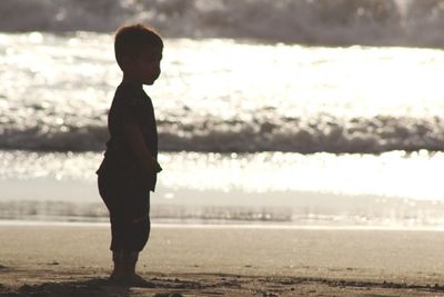 Boy on beach during sunset