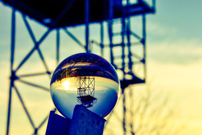 Close-up of crystal ball against blue sky