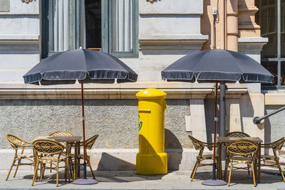 Empty chairs and tables in yard