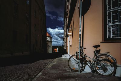Bicycle in city against sky