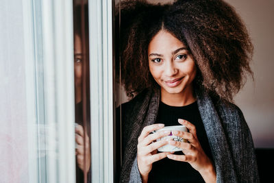 Close-up portrait of young woman drinking coffee