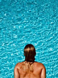 Rear view of woman in swimming pool