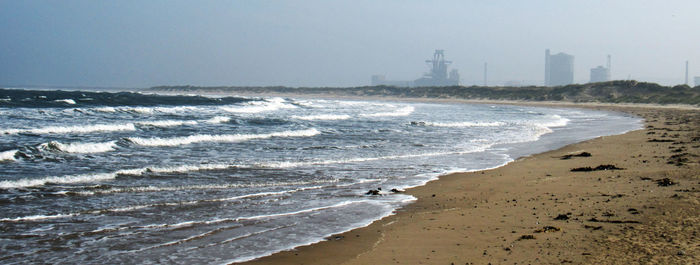 Scenic view of beach against clear sky