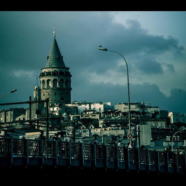 architecture, building exterior, built structure, sky, transfer print, low angle view, city, auto post production filter, tower, cloud - sky, building, cloud, church, outdoors, residential building, no people, travel destinations, religion, residential structure, dusk