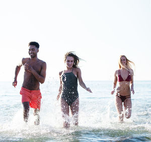 People on beach against sky