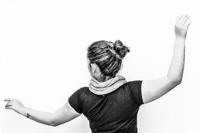 Rear view of boy standing against white background