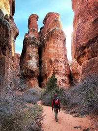 Rear view of women walking on rocks