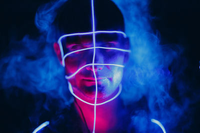 Close-up portrait of man against black background