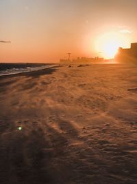 Scenic view of beach against sky during sunset