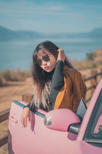 Side view of young woman using mobile phone