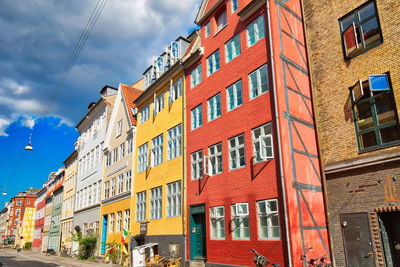 Low angle view of buildings in town against sky