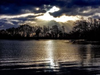 Scenic view of lake against cloudy sky