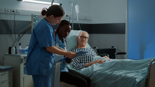 Nurse and doctor examining medical report