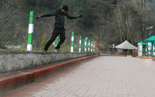 Full length rear view of man jumping