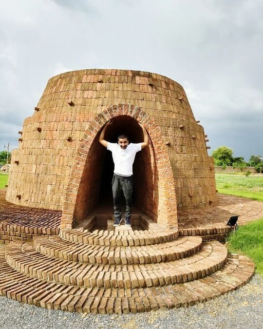 architecture, built structure, one person, history, the past, sky, day, arch, cloud - sky, full length, nature, standing, building exterior, front view, outdoors, ancient, leisure activity, traditional clothing, ancient civilization