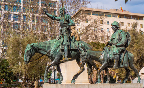 Statue against trees and plants