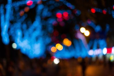 Defocused image of illuminated christmas lights at night