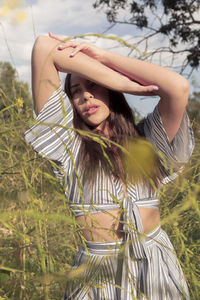 Beautiful latina woman in afternoon sun and flower fields