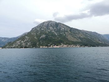 Scenic view of sea and mountains against sky