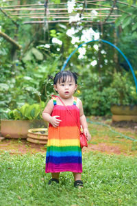 Portrait of boy standing on field