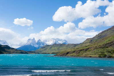 Scenic view of sea and mountains against sky