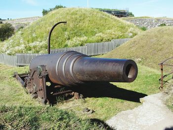 Close-up of old machinery on field