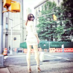 Full length of woman standing on tree trunk