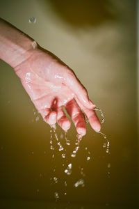 Close-up of wet hand in water