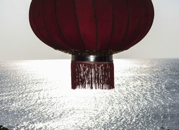 Close-up of red table by sea against sky