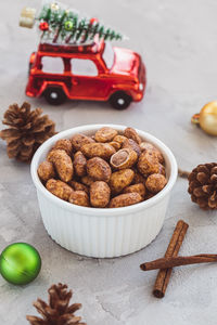 Candied or sugared almonds with honey and cinnamon in small porcelain bowl. christmas snack food