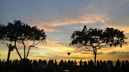 Silhouette people against sky during sunset