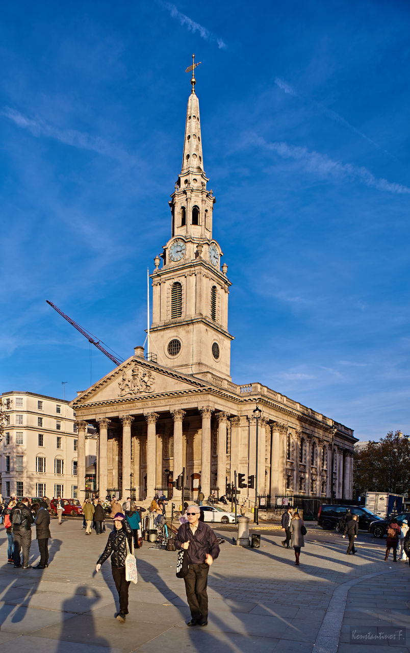 GROUP OF PEOPLE IN FRONT OF HISTORIC BUILDING AGAINST SKY