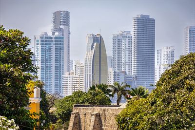 Buildings in city against sky