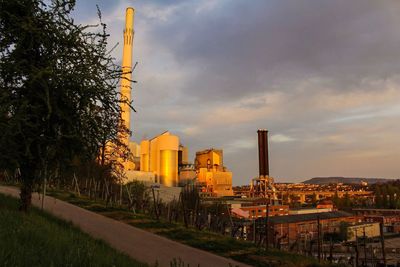 Factory against sky at sunset