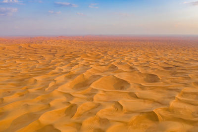 Scenic view of desert against sky during sunset