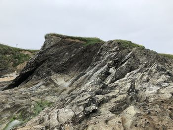 Low angle view of rock formation against sky