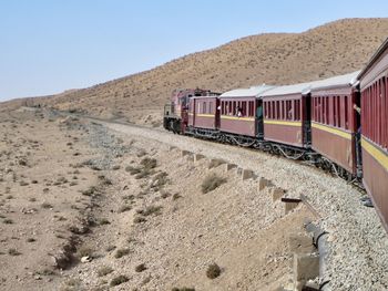 Train on desert against clear sky