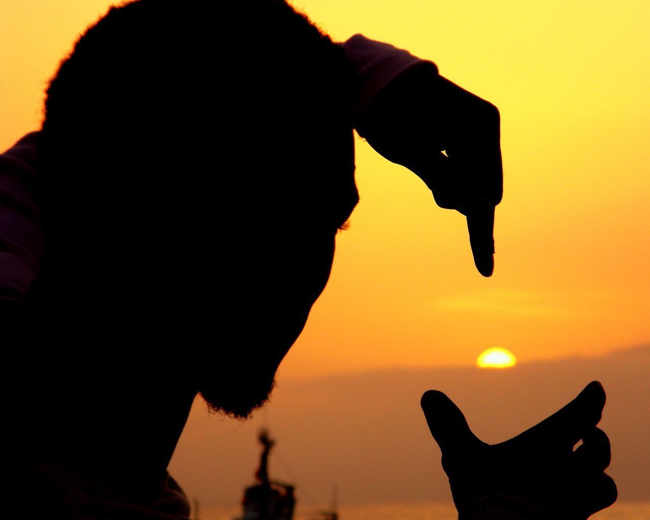 CLOSE-UP PORTRAIT OF SILHOUETTE MAN HOLDING ORANGE SKY DURING SUNSET