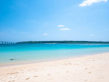Scenic view of beach against blue sky