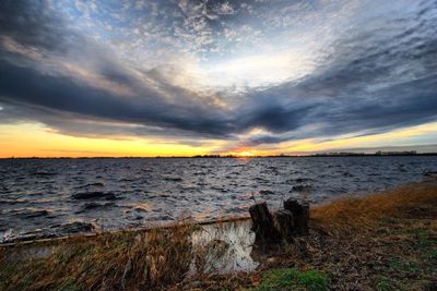 Scenic view of sea against cloudy sky