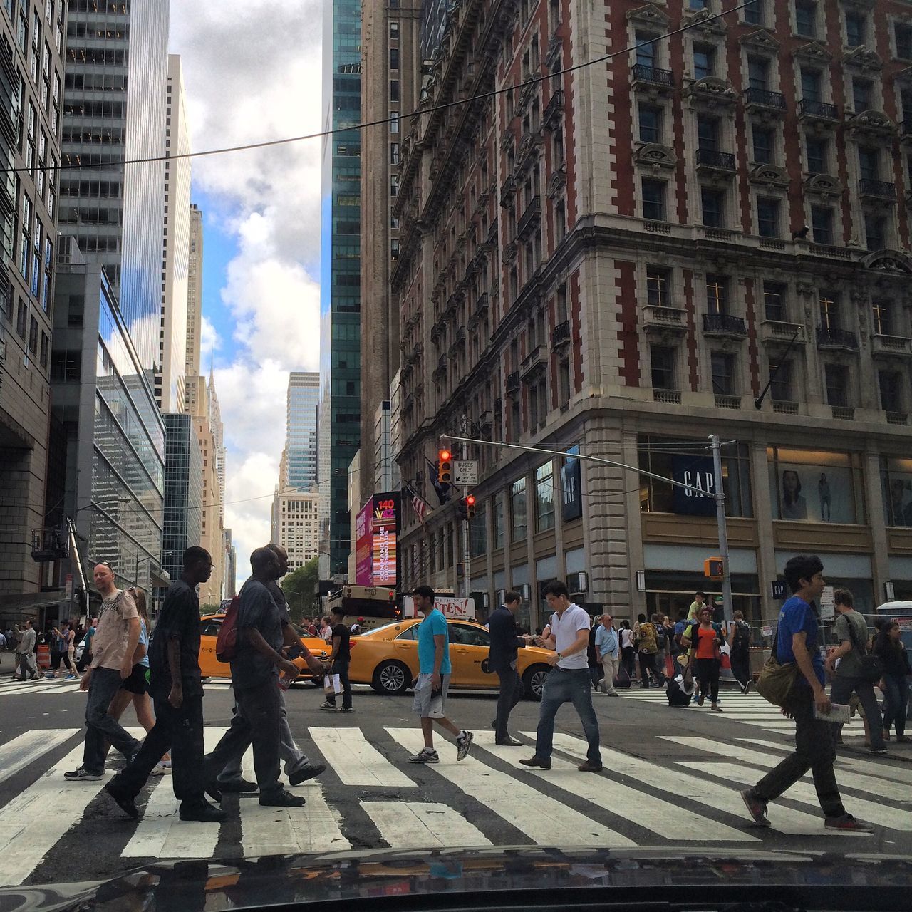 building exterior, architecture, built structure, city, street, city life, men, sky, person, large group of people, walking, building, cloud - sky, city street, transportation, lifestyles, car, land vehicle, road