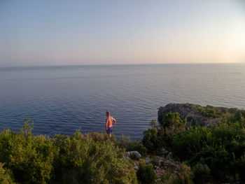 Man looking at sea against sky