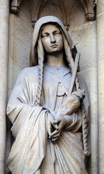 Close-up of angel statue against wall