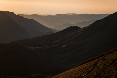 Scenic view of silhouette mountains against sky during sunset