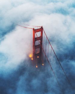 Aerial view of suspension bridge in foggy weather