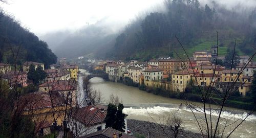 River amidst city against sky