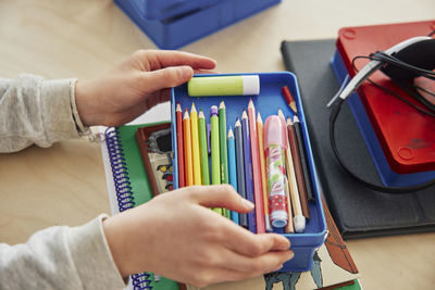 Child's hands holding pencil case