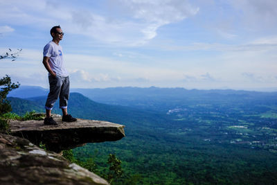 Man standing on landscape against sky