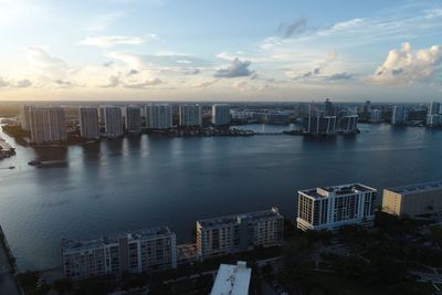 High angle view of buildings by sea against sky